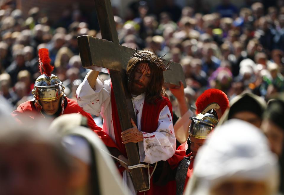 An actor playing Jesus Christ carries a Cross in a procession of the Way of the Cross on Good Friday at the Sanctuary of Kalwaria Zebrzydowska, near Krakow, southern Poland April 18, 2014.