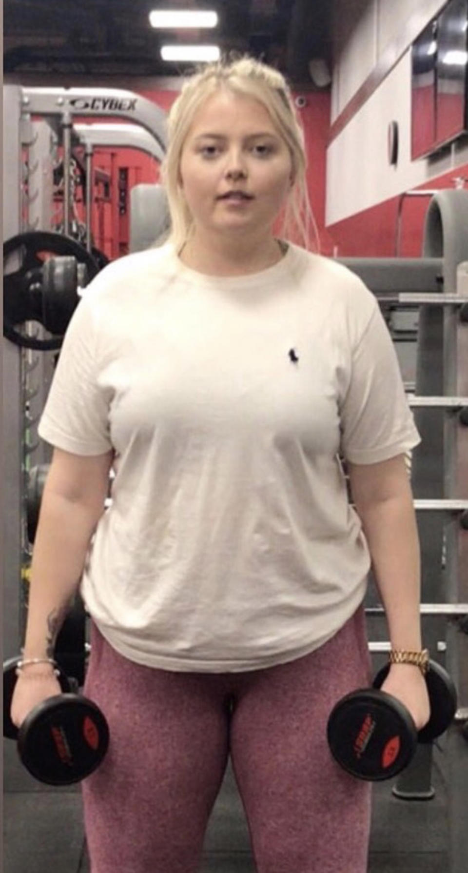 Woman holding weights in the gym