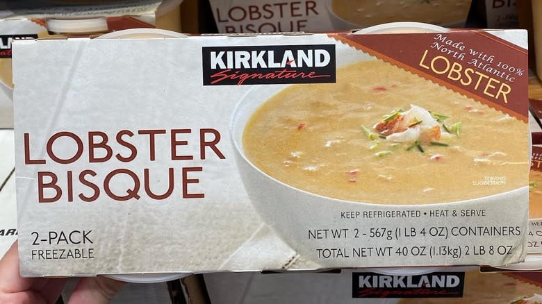 Person holding Kirkland lobster bisque box