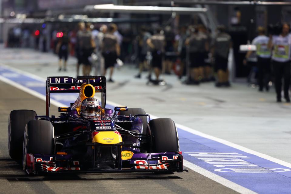 Red Bull Formula One driver Sebastian Vettel of Germany drives in the pit lane during the qualifying session of the Singapore Formula One Grand Prix September 21, 2013. REUTERS/Pablo Sanchez (SINGAPORE - Tags: SPORT MOTORSPORT F1)