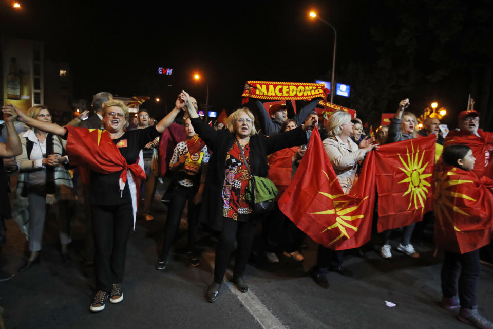 Supporters of a movement for voters to boycott the referendum, dance as they celebrate in central Skopje, Macedonia, after election officials gave low turnout figures, Sunday, Sept. 30, 2018. The crucial referendum on accepting a deal with Greece to change the country's name to North Macedonia to pave the way for NATO membership attracted tepid voter participation Sunday, a blow to Prime Minister Zoran Zaev's hopes for a strong message of support. (AP Photo/Thanassis Stavrakis)
