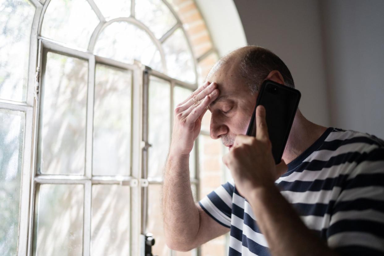 Man worried while talking on the smartphone