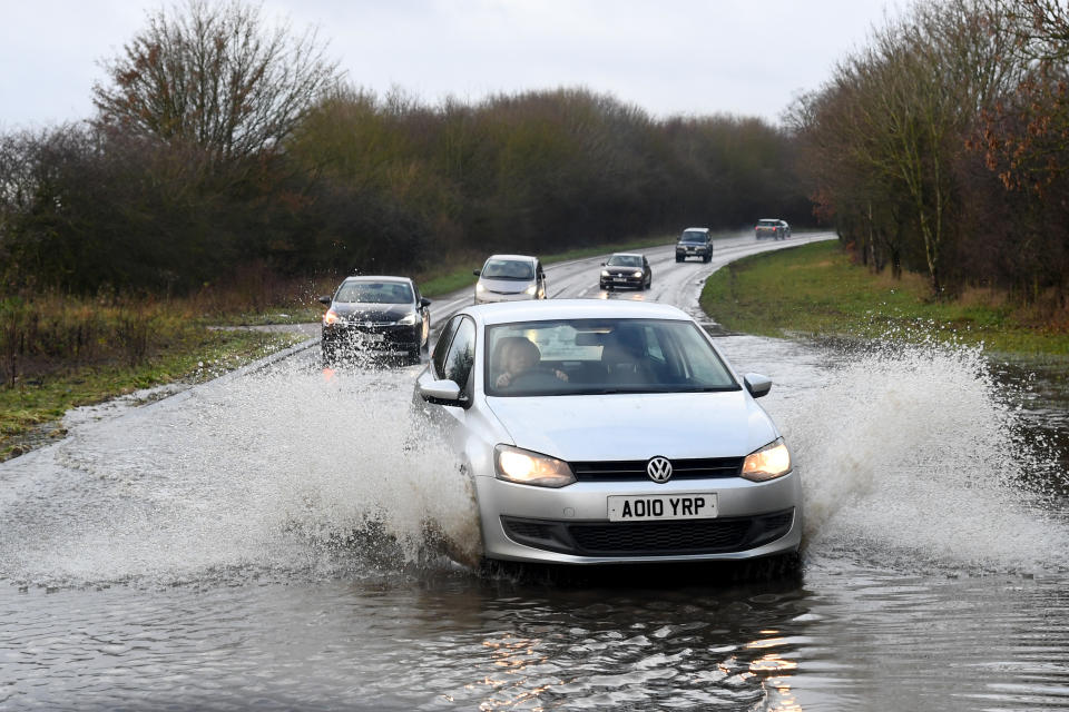 SUFFOLK, ENGLAND - DECEMBER 24: People drive through a flooded road following heavy rainfall on December 24, 2020 in Suffolk, United Kingdom . (Photo by Dave J Hogan/Getty Images)