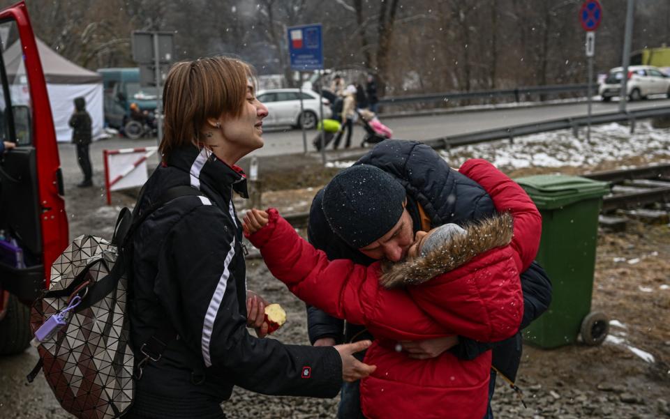 A Ukrainian family embraces one another after crossing the border into Poland - Omar Marques /Getty Images Europe 