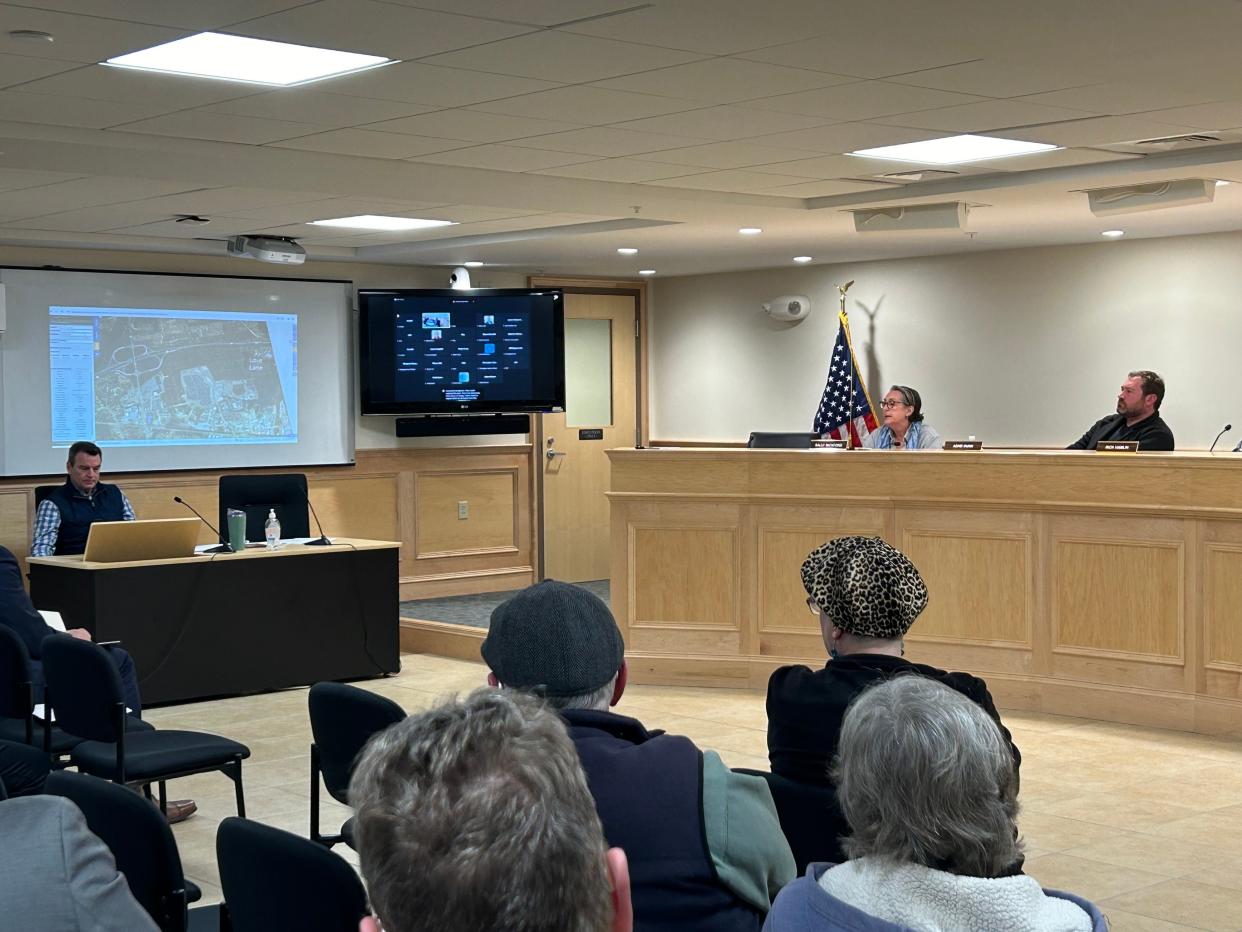 Dennis Planning Board members and town officials listen Monday in Dennis to a Housing Assistance Corporation presentation on a centralized family transition shelter planned at 1 Love Lane in South Dennis.