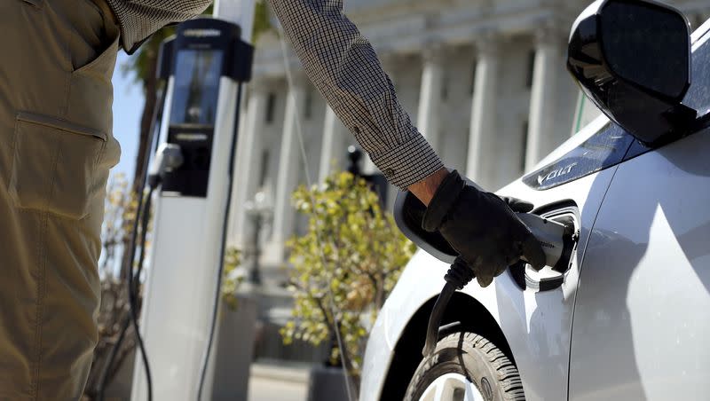 Jon Barney disconnects his electric car from a charging station at the Capitol in Salt Lake City on Thursday, Sept. 3, 2020.