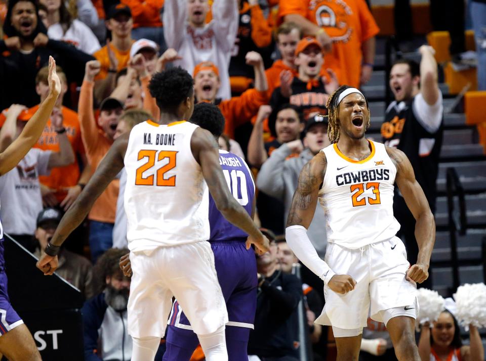 Oklahoma State's Tyreek Smith (23) celebrates a basket next to Kalib Boone (22) in the first half of the Cowboys' game against TCU on Saturday at Gallagher-Iba Arena in Stillwater.