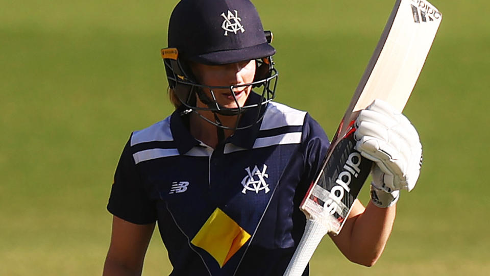 Ellyse Perry, pictured here raising her bat after scoring a century for Victoria against NSW.