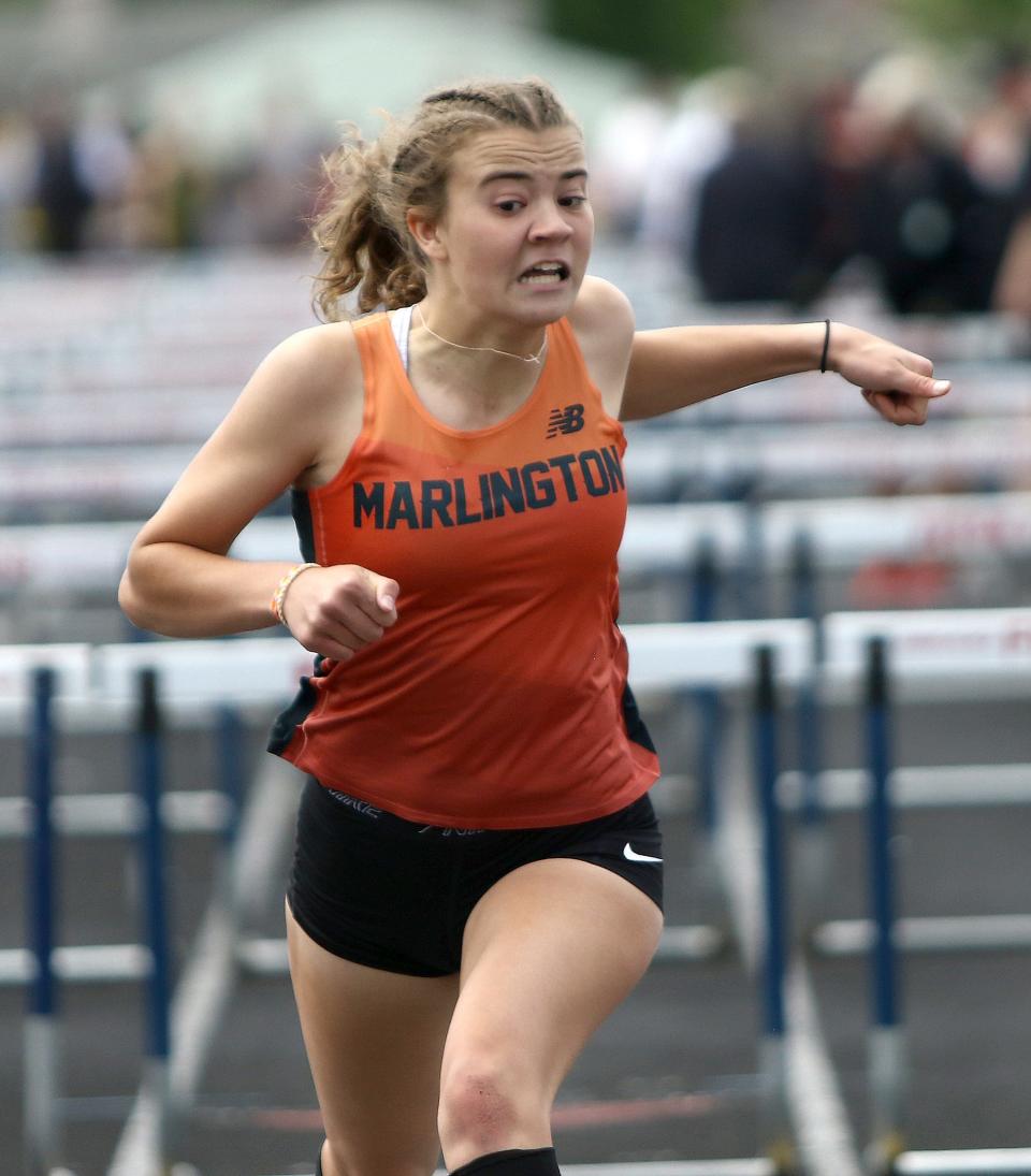 Marlington's Elizabeth Mason leans across the finish line for fourth place in the girls 100 meter hurdle at the Division II track and field regional finals held at Austintown Fitch High School, Saturday, May 28, 2022.