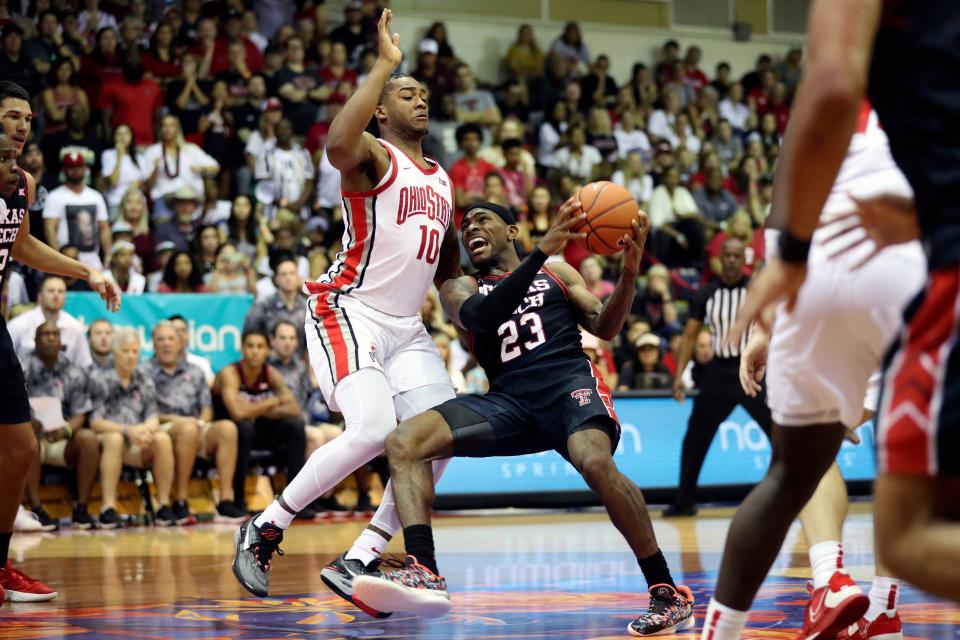 Texas Tech guard De'Vion Harmon (23) tries to get to the net under Ohio State forward Brice Sensabaugh (10) during the second half of an NCAA college basketball game, Wednesday, Nov. 23, 2022, in Lahaina, Hawaii. (AP Photo/Marco Garcia) ORG XMIT: HIMG107