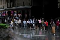 People wearing protective face masks walk on a street, following the coronavirus disease (COVID-19) outbreak, in Shanghai