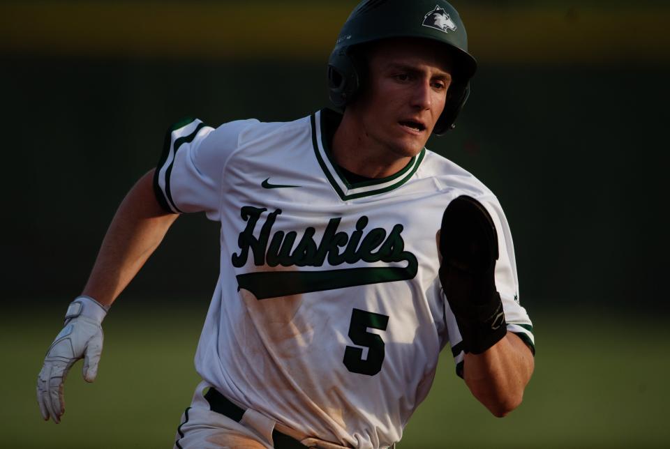 North's Cole Decker (5) heads to third base against Memorial during their game at North High School's Husky Field Thursday evening, April 13, 2023.