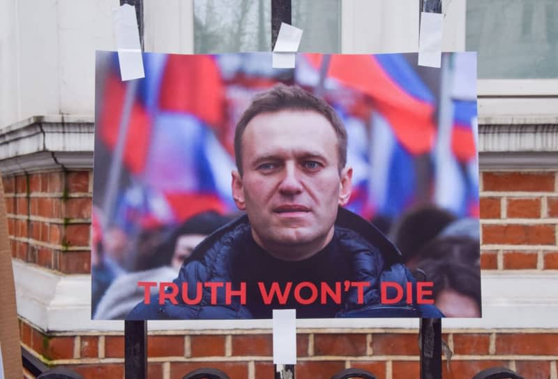 Supporters of Alexei Navalny continue to leave flowers and tributes at the makeshift memorial opposite the Russian Embassy in London following the death of the opposition leader in prison in Russia. Vuk Valcic/ZUMA Press Wire/dpa