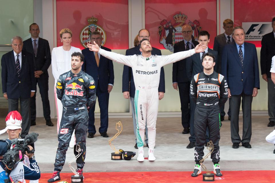 Thank you, up there: Lewis Hamilton celebrates after snatching victory from a dejected Daniel Ricciardo (left), thanks to a poor Red Bull pitstop in the 2016 Monaco Grand Prix