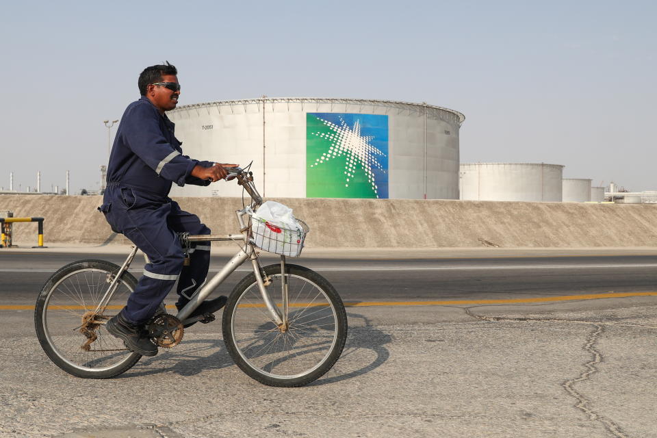 EASTERN PROVINCE, SAUDI ARABIA - OCTOBER 12, 2019: A worker rides a bicycle by oil tanks at an oil processing facility of Saudi Aramco, a Saudi Arabian state-owned oil and gas company, at the Abqaiq oil field. On 14 September 2019, two of the major Saudi oil facilities, Abqaiq and Khurais, suffered massive attacks of explosive-laden drones and cruise missiles; the Houthi movement, also known as Ansar Allah, claimed responsibility for the attacks. Stanislav Krasilnikov/TASS (Photo by Stanislav Krasilnikov\TASS via Getty Images)