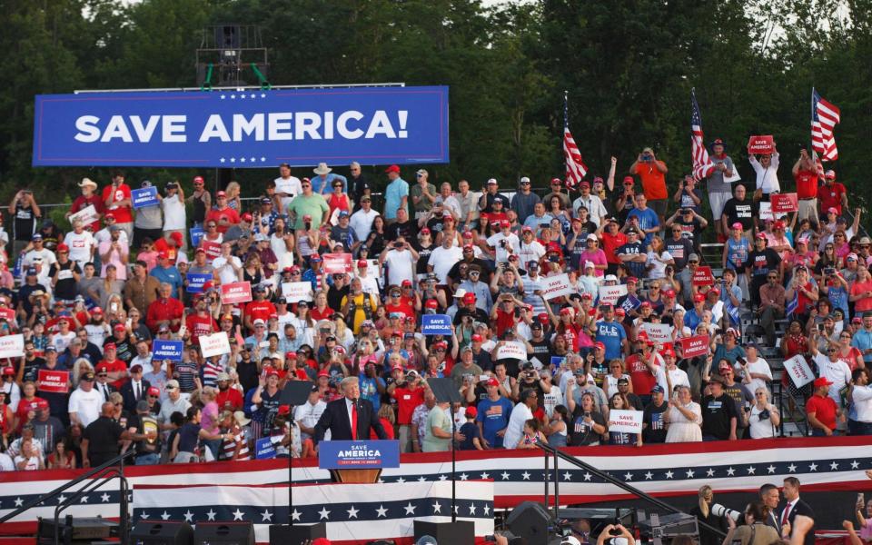 A "Save America" banner is seen above the bleachers as Donald Trump speaks - AFP