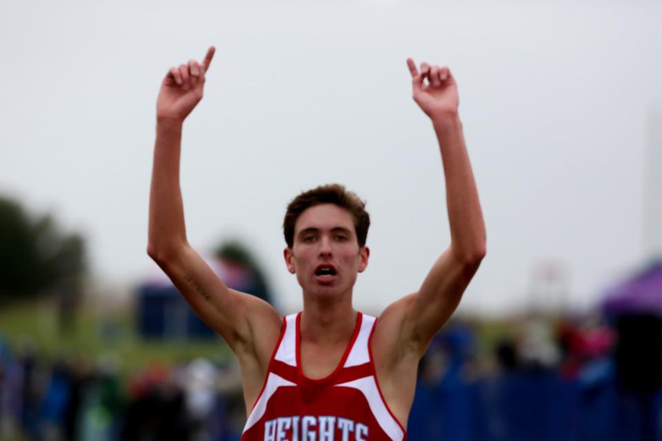 Shawnee Heights' Jackson Esquibel celebrates after winning the Class 5A State Cross County Championship.