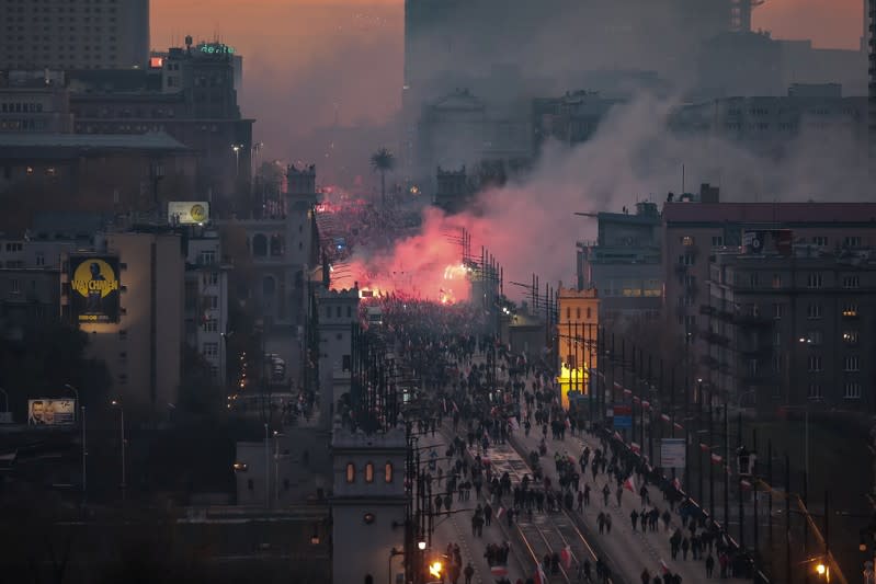 People burn flares during a march marking the National Independence Day in Warsaw