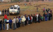 Police stand guard as voters queue to cast their ballots in Bekkersdal near Johannesburg, May 7, 2014. (REUTERS/Mike Hutchings)