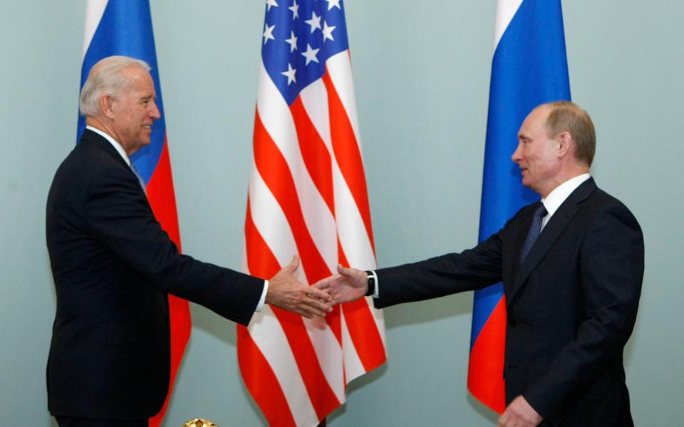 Vladimir Putin and Joe Biden at a meeting in Moscow in 2011 - AP