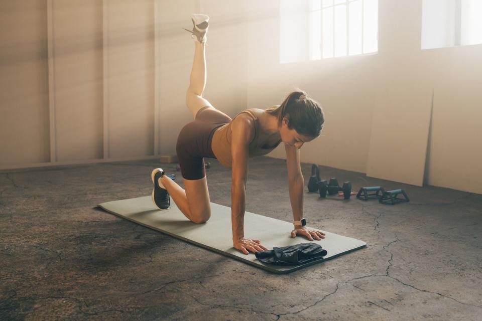 woman in sportswear doing home workout training