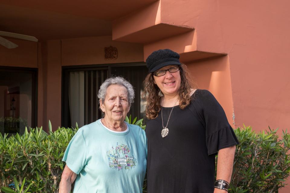 Amalia Kay and Kirsten Plambeck smile outside Kay's condo in Phoenix.