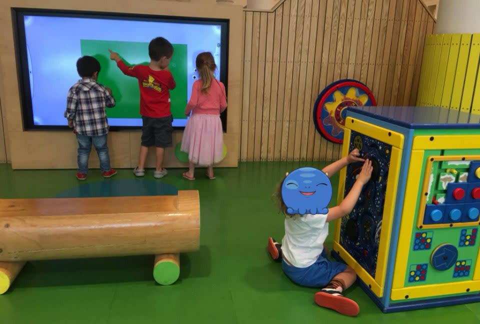 Children stare at a massive screen inside the shopping centre 'play pod'. Source: Facebook