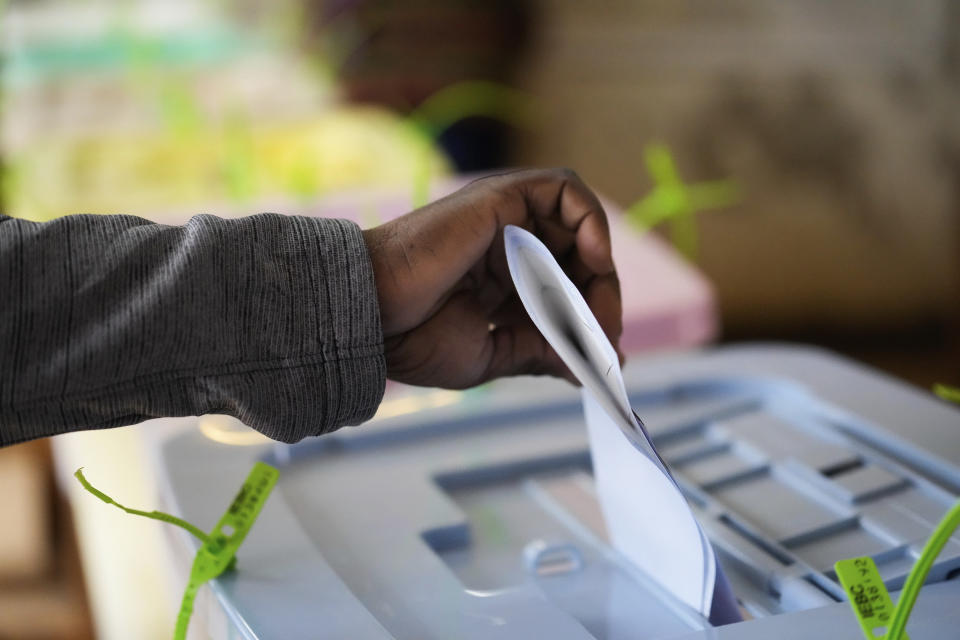 A man casts his ballots inside a polling station at the Kibera Primary School in Nairobi, Kenya, Tuesday, Aug. 9, 2022. Polls opened Tuesday in Kenya's unusual presidential election, where a longtime opposition leader who is backed by the outgoing president faces the deputy president who styles himself as the outsider. (AP Photo/Mosa'ab Elshamy)