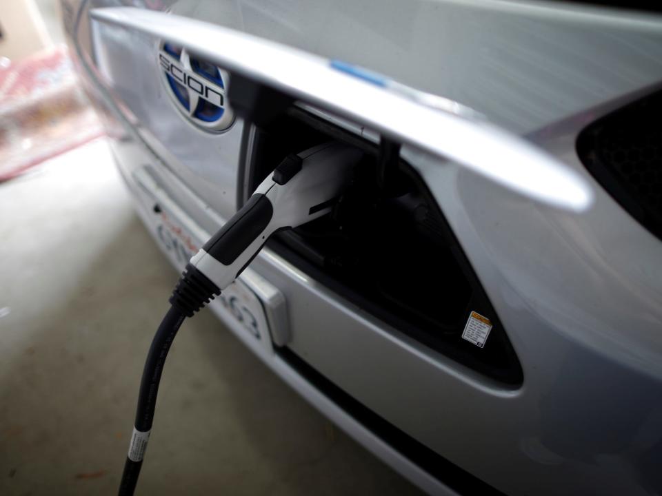 electric pump plugged into the back of a silver car