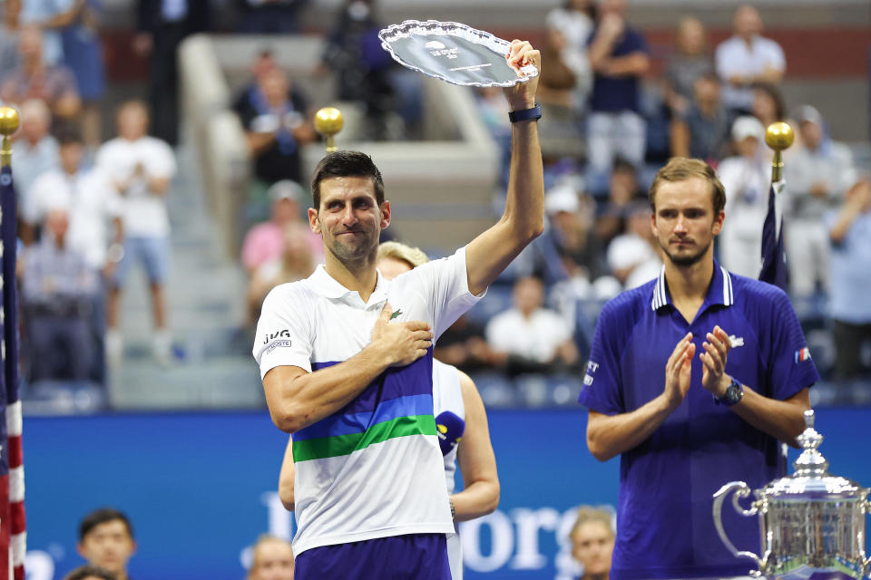 Novak Djokovic of Serbia celebrates with the runner-up trophy after being defeated by Daniil Medvedev of Russia during their Men's Singles final match on Day 14 of the 2021 U.S. Open on Sunday, September 12, 2021. / Credit: Matthew Stockman / Getty Images