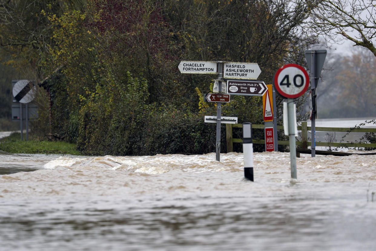 Floodwaters swamp a road in Tirley, near Tewkesbury, England, Sunday Nov. 17, 2019. Severe flooding has inflicted many parts of the country and a cold front is expected. (Steve Parsons/PA via AP)