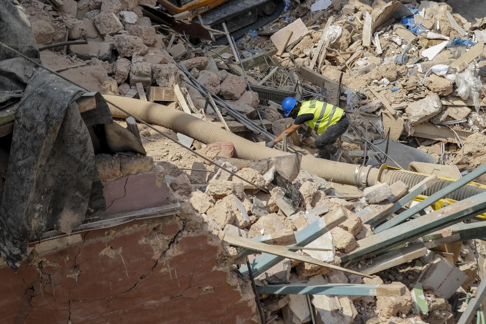 Rescuers search at the site of a collapsed building after getting signals there may be a survivor under the rubble, in Beirut, Lebanon, Saturday, Sept. 5, 2020. A pulsing signal was detected Thursday from under the rubble of a Beirut building that collapsed during the horrific port explosion in the Lebanese capital last month, raising hopes there may be a survivor still buried there. (AP Photo/Hassan Ammar)