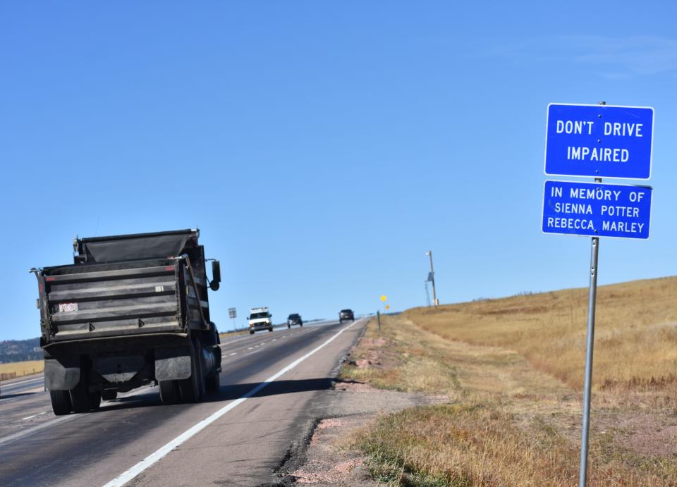 A sign marks where two young women were killed in a 2021 crash involving an impaired driver along U.S. Highway 287 near Livermore, Colo., on Oct. 19, 2023. The highway's 30-mile stretch from Colorado Highway 14 to the Wyoming border has a history of fatal crashes.