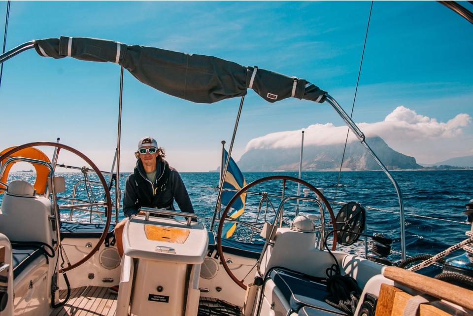 Man sailing a sailboat.