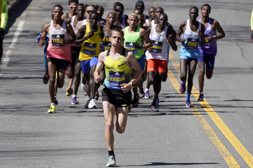 CJ Alberton, front, runs ahead of an elite group of runners during the 126th edition of the Boston Marathon, Monday, April 18, 2022, in Natick, Mass. (AP Photo/Steven Senne)