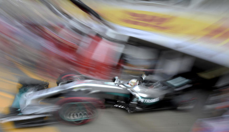 <p>In this photo taken with slow shutter speed Mercedes driver Lewis Hamilton of Britain starts for a Formula One training session in Hockenheim, Germany, July 29, 2016. (Photo: Jens Meyer/AP)</p>