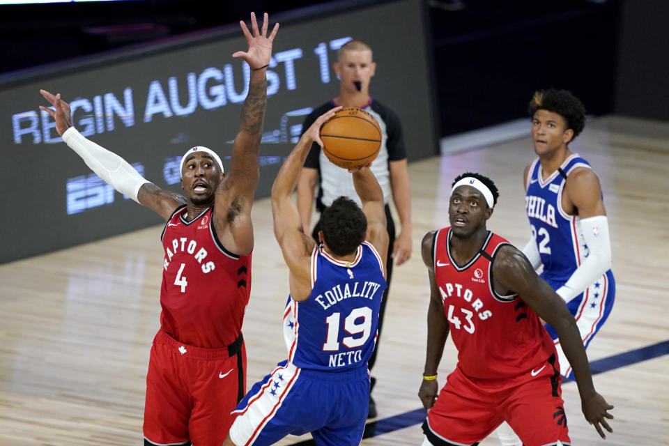 Philadelphia 76ers' Raul Neto (19) shoots a basket against Toronto Raptors' Rondae Hollis-Jefferson (4) and Pascal Siakam (43) during the first half of an NBA basketball game Wednesday, Aug. 12, 2020 in Lake Buena Vista, Fla. (AP Photo/Ashley Landis, Pool)