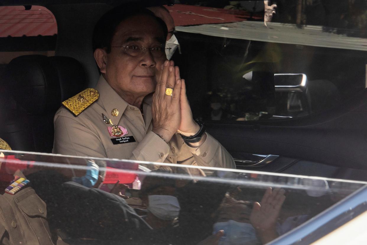 Prime Minister Prayuth Chan-ocha gestures with a traditional "wai" after visiting the families of the victims in the day care center attack in Uthai Sawan, north eastern Thailand, Friday, Oct. 7, 2022. 