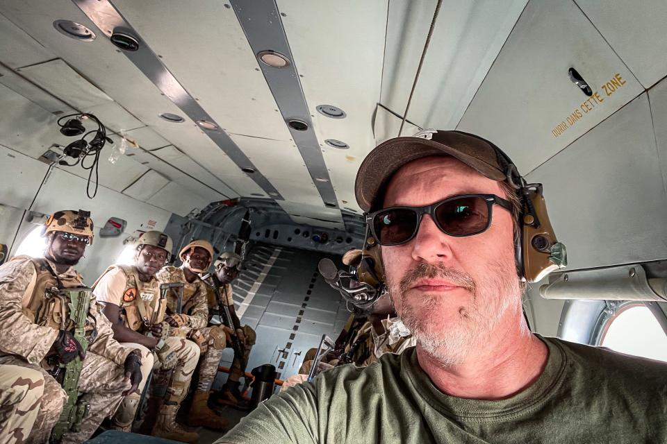 Photographer Andrew Craft takes a selfie while flying on a helicopter with Nigerian EFoN soldiers in Ouallam, Niger, in March 2022.