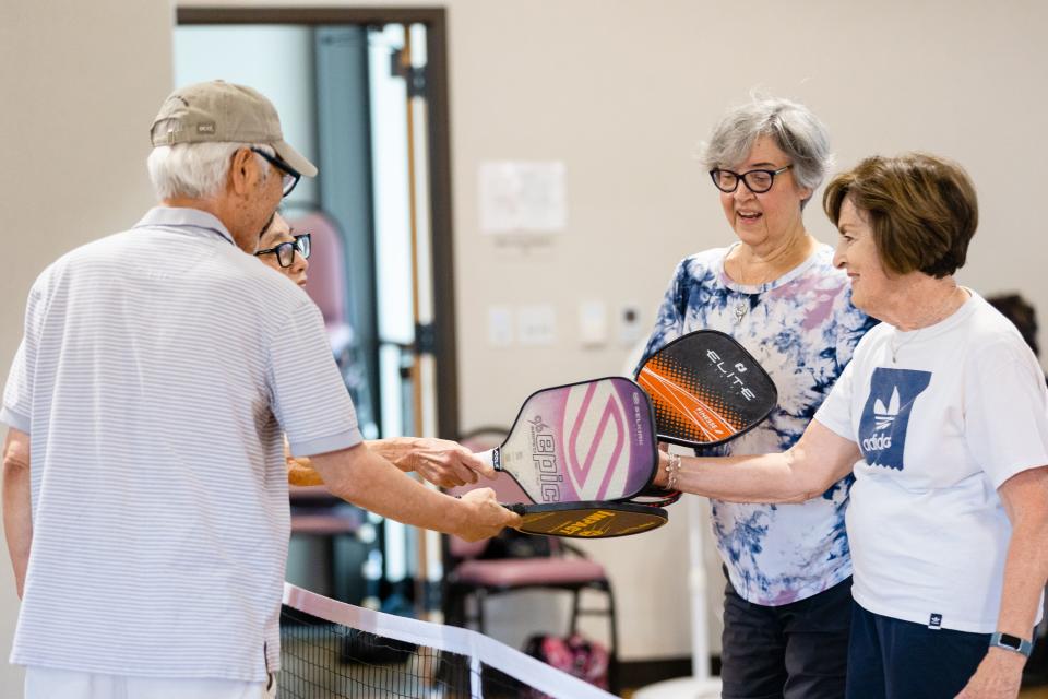 Kilho Kim, from left, Joo Ja Kim, Mary Lou Damjanovich and MaryEllen Reid congratulate each other after a game of pickleball at the Midvale Senior Center in Midvale on Friday, June 30, 2023. Pickleball is one activity offered at the center. | Megan Nielsen, Deseret News