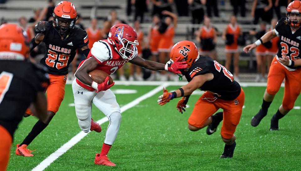 Manatee's tailback Ty'ron Jackson (3) puts the stiff arm on Sarasota's linebacker Kyser Bordones. Manatee Hurricanes stay undefeated with a 27-14 win over the Sarasota Sailors at Joe Kinnan Field at Hawkins Stadium on Friday night, September, 1, 2023, in Bradenton.