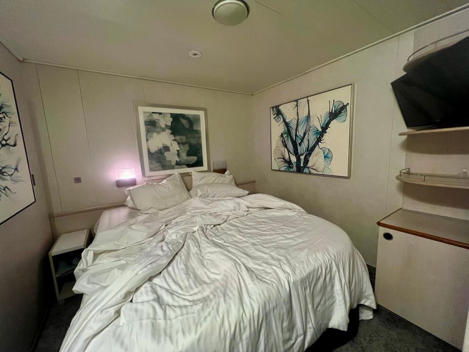 The author's bed with the TV on the wall.