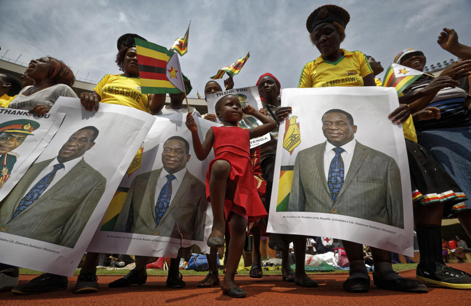 <p>A young girl marches in position as she mimics the military parade, accompanied by supporters holding posters of President Emmerson Mnangagwa, at his inauguration ceremony in the capital Harare, Zimbabwe Friday, Nov. 24, 2017. (Photo: Ben Curtis/AP) </p>
