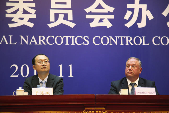 Yu Haibin, deputy director of the Office of China National Narcotics Control Commission, left, and Austin Moore, an attache to China for the U.S. Homeland Security Department hold a press conference on cracking down on fentanyl trafficking in Xingtai in northern China's Hebei province Thursday, Nov. 7, 2019. A Chinese court sentenced nine fentanyl traffickers Thursday in a case that was a culmination of a rare collaboration between Chinese and U.S. law enforcement to crack down on global networks that manufacture and distribute lethal synthetic opioids. (AP Photo/Erika Kinetz)