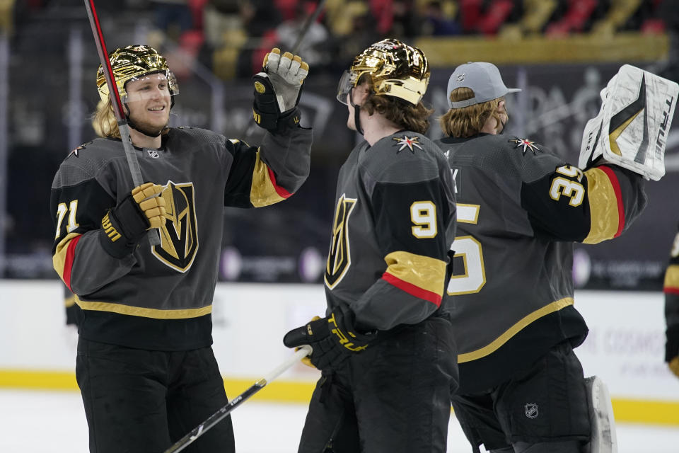 Vegas Golden Knights center William Karlsson (71) and center Cody Glass (9) celebrate after defeating the Los Angeles Kings in an NHL hockey game Monday, March 29, 2021, in Las Vegas. (AP Photo/John Locher)