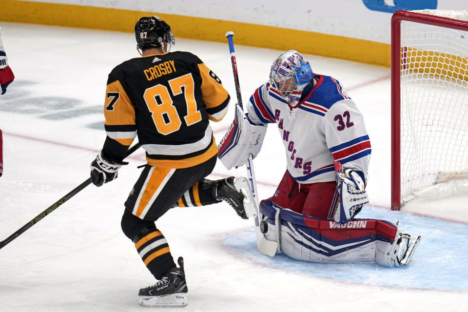 Pittsburgh Penguins' Sidney Crosby (87) can't get his stick on a rebound in front of New York Rangers goaltender Jonathan Quick (32) during the first period of an NHL hockey game in Pittsburgh, Wednesday, Nov. 22, 2023. (AP Photo/Gene J. Puskar)