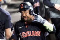 Cleveland Guardians' José Ramírez celebrates in the dugout after his two-run home run against the Chicago White Sox during the eighth inning of a baseball game Friday, May 10, 2024, in Chicago. (AP Photo/Charles Rex Arbogast)