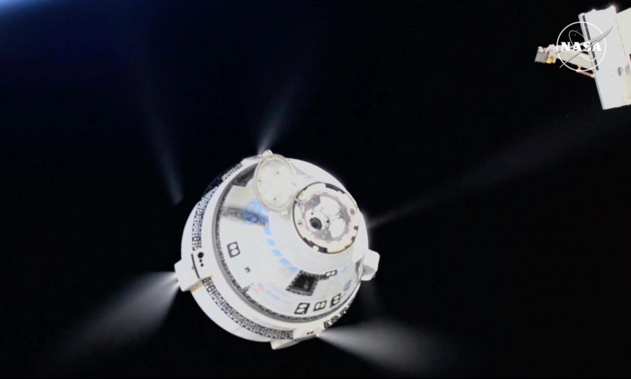 <span>The unmanned Boeing Starliner capsule fires its thrusters as it pulls away from the International Space Station on Friday.</span><span>Photograph: AP</span>