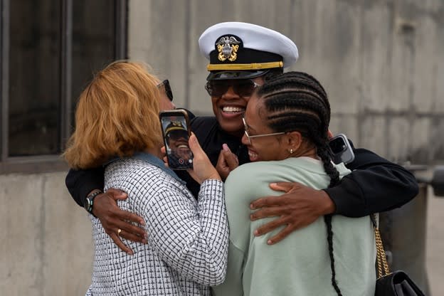 Lt. j.g. Alescia Austin, assigned to the the guided-missile cruiser USS Leyte Gulf (CG 55), greats her family. U.S. Navy photo by Mass Communication Specialist 2nd Class Manvir Gill.