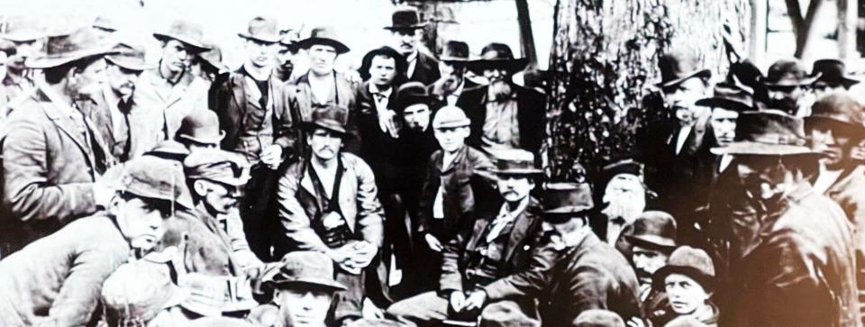 July 14, 1891: Miners and business leaders met at Thistle Switch to plot a way to end convict leasing after Tennessee Coal Mining Co. replaced striking miners with convicts at its Briceville mine. Welsh mining engineer David Thomas is sitting in the center by the tree.